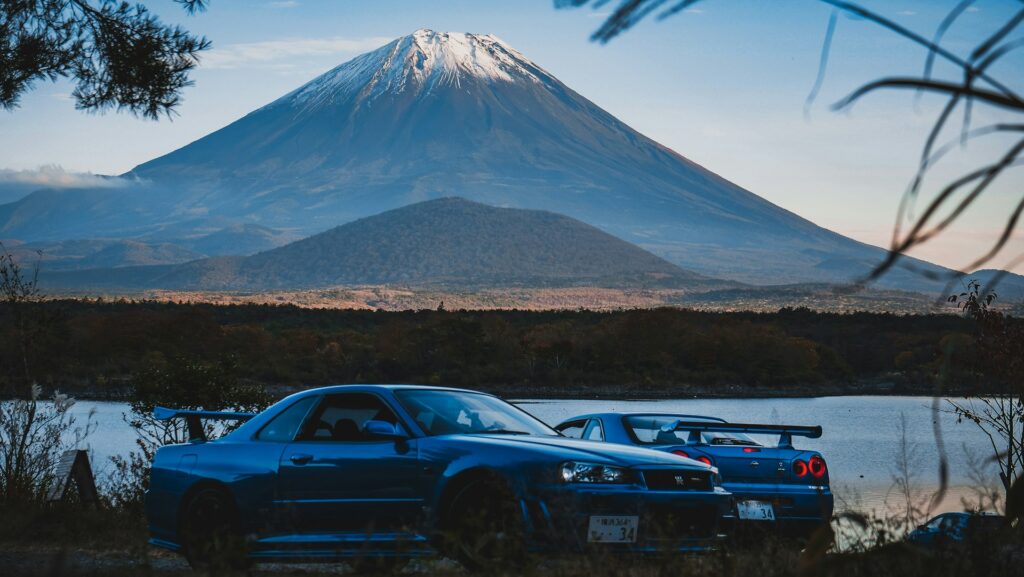 nissan skylines in front of a mountain